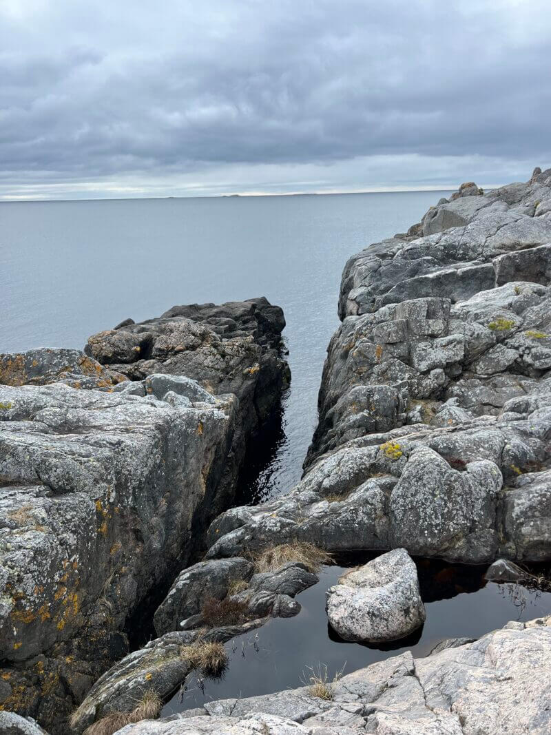 Rocky coastal cliffs with narrow sea inlet on Yxlan Island, Stockholm Archipelago Trail